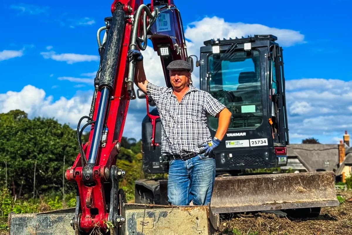 Hampshire Paddock Management operator standing beside the 8-tonne excavator brought in for the East Meon stump removal