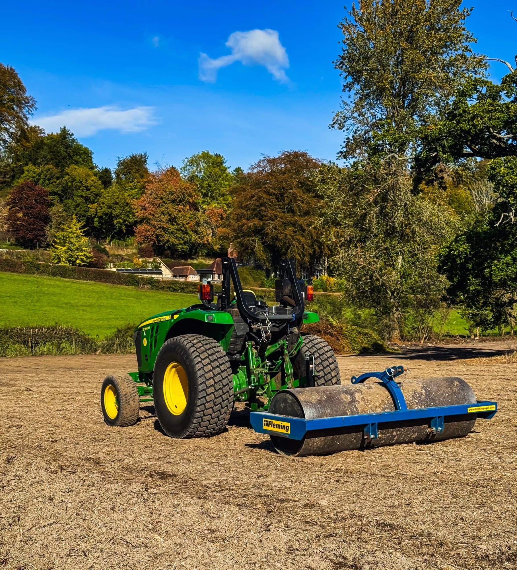 John Deere 4066M compact tractor pulling a Fleming roller across the rotavated East Meon paddock on a sunny autumn day