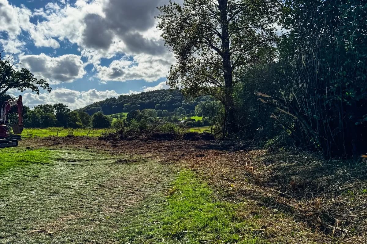 Stump holes filled and tracked level across an East Meon paddock, with the Meon valley beyond