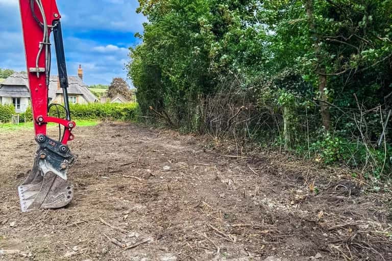 Cleared and levelled strip of ground along the upper boundary of an East Meon field, ready for new stables